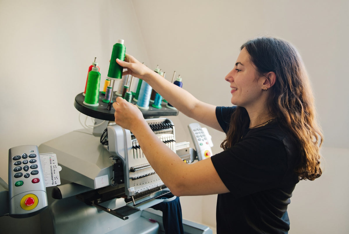 Louise aan de borduurmachine in het atelier in Gent | Tice Nits