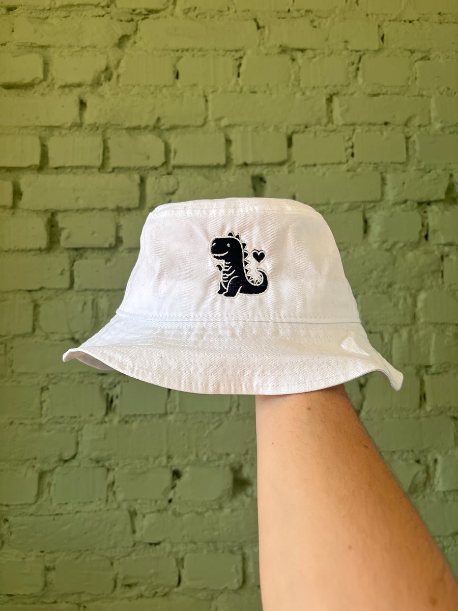Witte bucket hat met een geborduurde zwarte dinosaurus