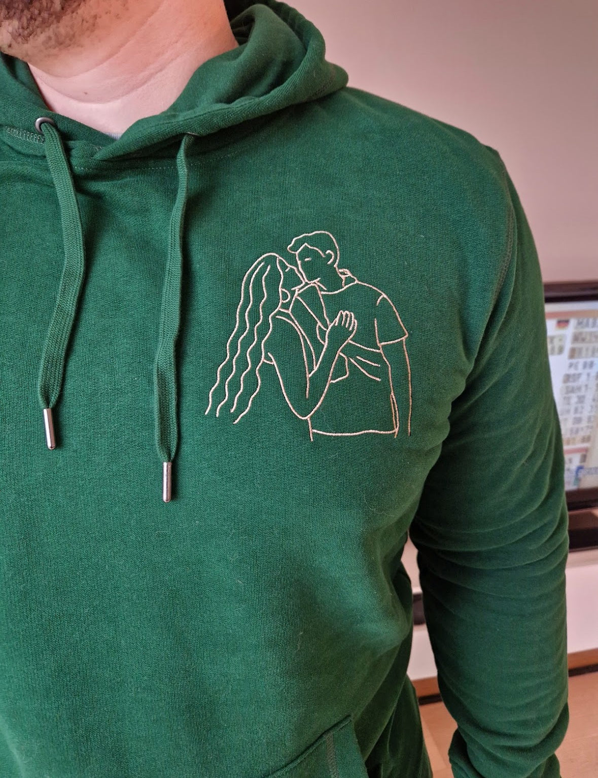 Groene hoodie met witte lijntekening, gedragen, geborduurd door Tice Nits