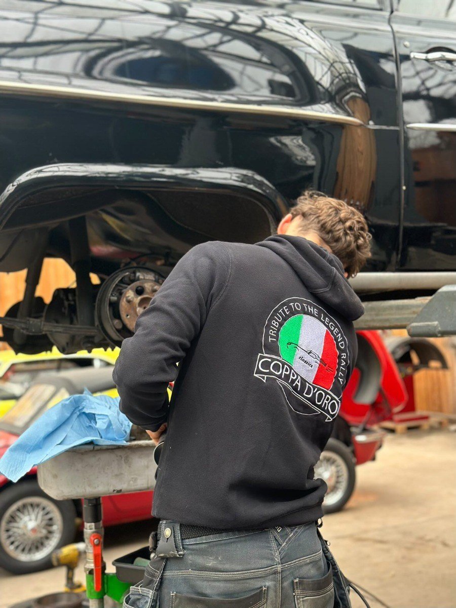 Mechanic with the Coppa d'Oro logo on the back of his hoodie
